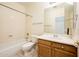 Full bathroom featuring a tub, shower, toilet, vanity, mirror, and tile floors at 16515 N 71St Dr, Peoria, AZ 85382