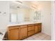 Bathroom with tile floor, double vanity, and large mirror at 16515 N 71St Dr, Peoria, AZ 85382