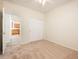Bedroom features tan carpet, a ceiling fan, an ensuite bathroom, and closet at 16515 N 71St Dr, Peoria, AZ 85382