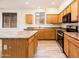 Well-lit kitchen featuring stainless steel appliances and spacious island at 16515 N 71St Dr, Peoria, AZ 85382