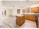 Open kitchen with wooden cabinets, island and bright lighting at 16515 N 71St Dr, Peoria, AZ 85382