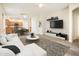 Modern living room with white sectional, decorative rug, and media center at 16515 N 71St Dr, Peoria, AZ 85382
