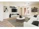 Modern living room featuring access to the patio, wood floors, and bright lighting at 16515 N 71St Dr, Peoria, AZ 85382