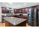 A modern kitchen featuring stainless steel appliances, wood cabinets, and granite countertops at 1934 E Cypress Tree Dr, Gilbert, AZ 85234