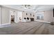 Bright living room featuring plush carpet, ceiling fans, and multiple entryways at 1934 E Cypress Tree Dr, Gilbert, AZ 85234