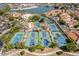 A high angle view of numerous tennis and pickleball courts at a lakeside community, surrounded by tropical trees at 1934 E Cypress Tree Dr, Gilbert, AZ 85234