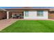 The backyard features a covered patio and artificial grass, providing a comfortable outdoor living space at 19627 W Badgett Ln, Litchfield Park, AZ 85340