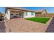 A covered patio and artificial grass create a comfortable and inviting outdoor living space at 19627 W Badgett Ln, Litchfield Park, AZ 85340