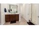 Bathroom featuring a large vanity with double sinks, wood floors, and glass enclosed shower at 19627 W Badgett Ln, Litchfield Park, AZ 85340