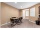 This dining room features a glass table, seating for six, and neutral paint at 19627 W Badgett Ln, Litchfield Park, AZ 85340