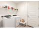Well-equipped laundry room featuring a washer, dryer, and ample shelving for storage at 19627 W Badgett Ln, Litchfield Park, AZ 85340