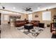 Inviting living room with open floorplan, tile floors, ceiling fan and easy access to kitchen and dining at 19627 W Badgett Ln, Litchfield Park, AZ 85340
