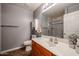 Clean bathroom features a wood vanity, white sink, and shower, offering a simple and functional design at 205 N 74Th St # 201, Mesa, AZ 85207