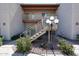 A condo exterior showing the entryway with stairs and landscaping for a clean, inviting look at 205 N 74Th St # 201, Mesa, AZ 85207