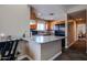 Open kitchen with stainless steel appliances, tile floors, counter seating, and views into the dining and living areas at 205 N 74Th St # 201, Mesa, AZ 85207