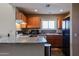 Well-lit kitchen features granite countertops, stainless appliances, and a breakfast bar for casual dining at 205 N 74Th St # 201, Mesa, AZ 85207