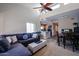 Cozy living room with a plush sectional, kitchen view, dining area, and bright, airy feel from high ceilings at 205 N 74Th St # 201, Mesa, AZ 85207