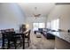 Spacious living room with neutral carpet, dining area, vaulted ceilings and a sliding glass door for ample light at 205 N 74Th St # 201, Mesa, AZ 85207