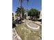 Beautiful community landscaping with decorative rocky water feature and mature shade trees and manicured shrubs at 205 N 74Th St # 201, Mesa, AZ 85207