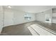 Bright living room featuring gray wood floors, a window, and white walls at 22375 S Manzanilla Rd, Buckeye, AZ 85326