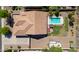 Aerial view of a house featuring a large backyard with a sparkling pool, patio furniture, and desert landscaping at 226 W Crimson Sky Ct, Casa Grande, AZ 85122