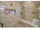 Modern tiled shower with built-in niche and bench seating for a spa-like experience at 226 W Crimson Sky Ct, Casa Grande, AZ 85122