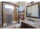 Bathroom with a walk-in shower and a dark wood vanity with granite countertop at 226 W Crimson Sky Ct, Casa Grande, AZ 85122