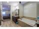 The bathroom features a soaking tub, granite countertops, and a large window at 226 W Crimson Sky Ct, Casa Grande, AZ 85122
