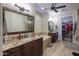 A beautiful bathroom with granite counters, dual sinks, and a soaking tub at 226 W Crimson Sky Ct, Casa Grande, AZ 85122