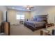 The main bedroom has hardwood floors, a ceiling fan, and a large window at 226 W Crimson Sky Ct, Casa Grande, AZ 85122