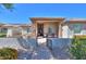 Inviting home entrance featuring stone columns, desert landscaping, and covered porch with seating area at 226 W Crimson Sky Ct, Casa Grande, AZ 85122