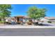 Charming single-story home featuring a well-manicured front yard, stone accents, and a vibrant desert landscape at 226 W Crimson Sky Ct, Casa Grande, AZ 85122