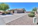 View of home with three-car garage, wide driveway, desert landscaping, and a well-maintained exterior at 226 W Crimson Sky Ct, Casa Grande, AZ 85122