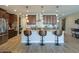 Kitchen with dark wood cabinets, a white backsplash, stainless appliances, a central island and pendant lighting at 226 W Crimson Sky Ct, Casa Grande, AZ 85122