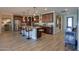 Kitchen with dark wood cabinets, stainless appliances, large central island, and pendant lighting at 226 W Crimson Sky Ct, Casa Grande, AZ 85122