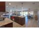 Spacious kitchen featuring a large island with granite countertops, dark wood cabinets, and pendant lighting at 226 W Crimson Sky Ct, Casa Grande, AZ 85122