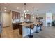 Spacious kitchen with dark wood cabinets, granite countertops, and a central island with bar seating at 226 W Crimson Sky Ct, Casa Grande, AZ 85122