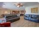 An open floor plan with hardwood floors connects the living room, kitchen, and dining area at 226 W Crimson Sky Ct, Casa Grande, AZ 85122