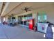 Covered outdoor patio with ceiling fans, dining table, and a fun red retro refrigerator at 226 W Crimson Sky Ct, Casa Grande, AZ 85122