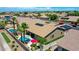 Stunning aerial view of a home with a private pool, mature palm trees, and a well-maintained backyard at 230 S 122Nd Ln, Avondale, AZ 85323