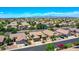 Expansive aerial view of a desert community with tile-roofed homes and mountain backdrop at 230 S 122Nd Ln, Avondale, AZ 85323