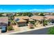 Aerial view showcasing a home with solar panels, desert landscaping, and a manicured lawn in a residential neighborhood at 230 S 122Nd Ln, Avondale, AZ 85323