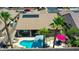 Aerial view showcasing a home with a refreshing pool, outdoor seating, solar panels, and lush landscaping for privacy at 230 S 122Nd Ln, Avondale, AZ 85323