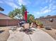 Backyard featuring patio seating, gravel landscaping, privacy fence, and desert plants at 230 S 122Nd Ln, Avondale, AZ 85323