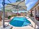 Relaxing backyard featuring a sparkling pool, lush greenery, and ample space for lounging and outdoor activities at 230 S 122Nd Ln, Avondale, AZ 85323