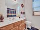 Bathroom featuring a vanity with a sink, toilet, and shower with curtain at 230 S 122Nd Ln, Avondale, AZ 85323