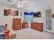 Bright bedroom featuring a ceiling fan, wood furnishings, a TV, decor, and an exterior door with access to the outside at 230 S 122Nd Ln, Avondale, AZ 85323