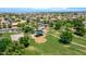 Community park with a playground, lush greenery, and walking paths, offering a recreational space for residents at 230 S 122Nd Ln, Avondale, AZ 85323