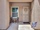 Charming front porch with seating, security door, and decorative wreath at 230 S 122Nd Ln, Avondale, AZ 85323