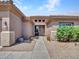 Inviting front entrance featuring a tile roof and desert landscaping at 230 S 122Nd Ln, Avondale, AZ 85323